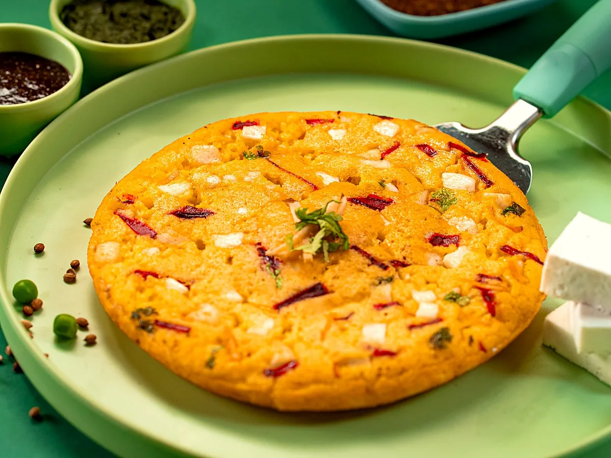 M-Special Moonglet on a pale green plate, studded with paneer and vegetables